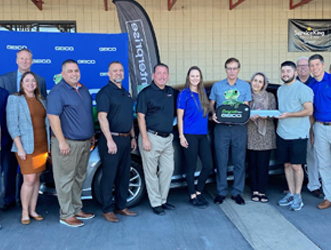 large-group-of-people-outside-body-shop